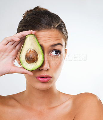 Buy stock photo Woman, face and avocado for health in studio for wellness detox, healthy skin and hydration with omega 3. Model, person and fruit for organic cosmetics, natural beauty or skincare on white background