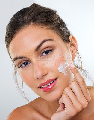 Buy stock photo Woman, cream on face and skincare for beauty, dermatology with cosmetics product or moisturizer in studio. Portrait, skin wellness with sunscreen or lotion for glow and antiaging on white background