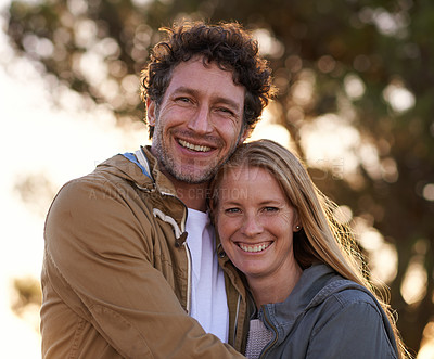 Buy stock photo A cropped portrait of a happy affectionate couple standing together outdoors