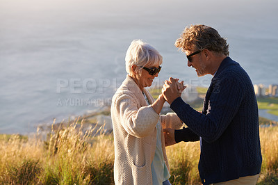 Buy stock photo Happy, couple and dance outdoor on holiday, holding hands with love and relax on hill or mountain in Cape Town. Mature, people and embrace with kindness on vacation adventure in nature together