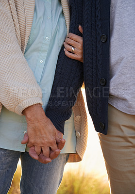 Buy stock photo Cropped view of a senior couple holding hands