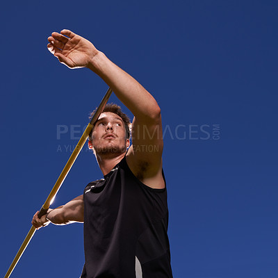 Buy stock photo Shot of a lone man throwing a javelin outside