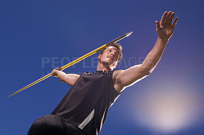 Buy stock photo Shot of a lone man throwing a javelin outside