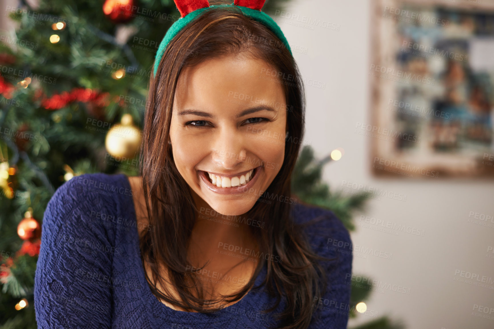 Buy stock photo Woman, face and Christmas headband in house or home living room for festive event, holiday celebration or december vacation. Portrait, smile or happy xmas person with fun accessory or tree decoration