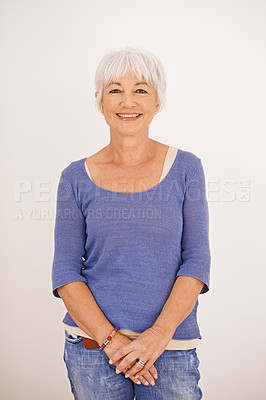 Buy stock photo Portrait of a happy mature woman posing against a light background