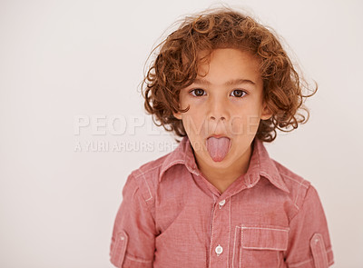 Buy stock photo Boy, child and portrait in studio with tongue out for funny face, joke or games by white background. Kid, mouth and comic gesture with fashion, playful and emoji with trendy style, shirt or clothes