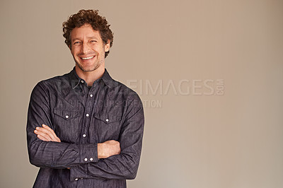 Buy stock photo Portrait of a handsome young man crossing his arms