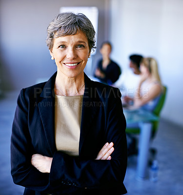 Buy stock photo Portrait of a businesswoman standing in front of her colleagues during a meeting