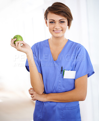 Buy stock photo Woman, nurse and happy portrait with apple in medical office, nutrition and healthy food choice, professional nursing career. Dietician, healthcare and fruit for wellness with fibre and vitamins
