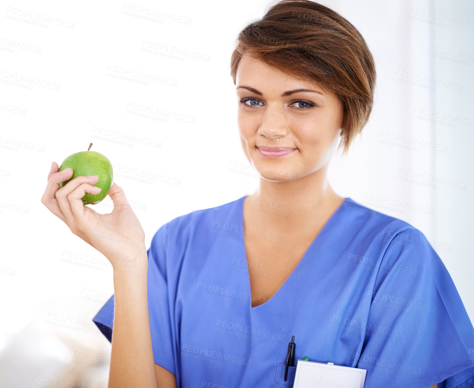 Buy stock photo Woman, nurse and smile portrait with apple in medical office, nutrition and healthy food choice, professional nursing career. Dietician, healthcare and fruit for wellness with fibre and vitamins
