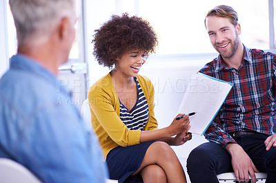 Buy stock photo Funny, team and business people with document for discussion in meeting at creative startup. Happy group, diverse professionals and laugh with paperwork for joke, planning or writers in collaboration