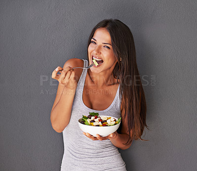 Buy stock photo Woman is eating a salad, healthy food and nutrition, portrait and vegetables isolated on wall background. Happy, vegan and health with wellness, diet and female model to lose weight with mockup space
