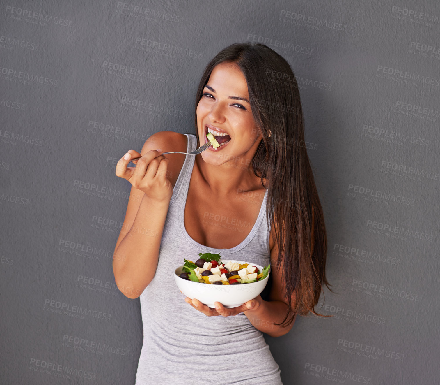 Buy stock photo Woman is eating a salad, healthy food and nutrition, portrait and vegetables isolated on wall background. Happy, vegan and health with wellness, diet and female model to lose weight with mockup space