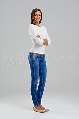 Buy stock photo Portrait, confidence and happy woman in studio for fashion isolated on a white background mockup space. Arms crossed, young person and student in casual clothes, jeans or trendy style in Argentina