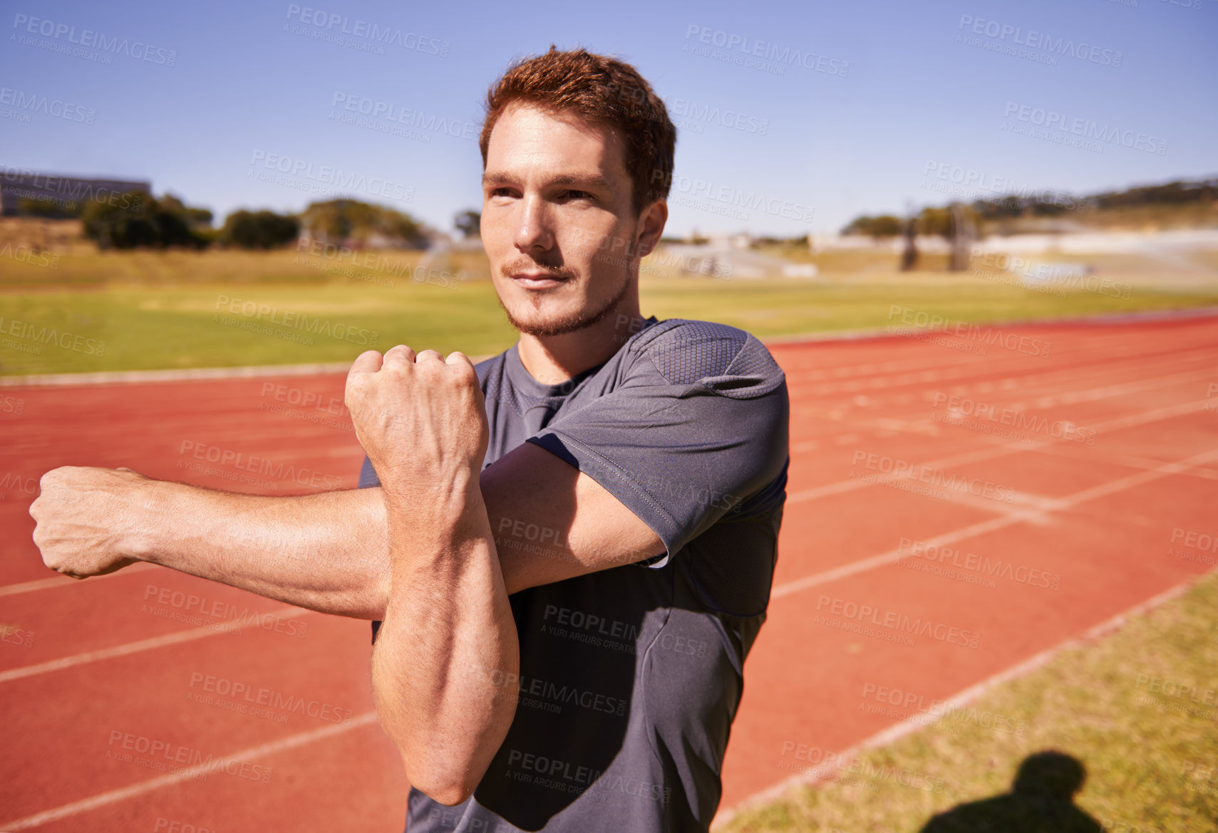 Buy stock photo Fitness, arms and man runner stretching in stadium for race, marathon or competition training for health. Sports, vision and male athlete with warm up exercise for running cardio workout on track.