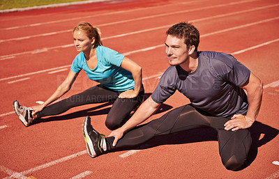 Buy stock photo Workout, legs and couple stretching in stadium for race, marathon or competition training for health. Sports, energy and runner athletes with warm up exercise for running cardio on outdoor track.