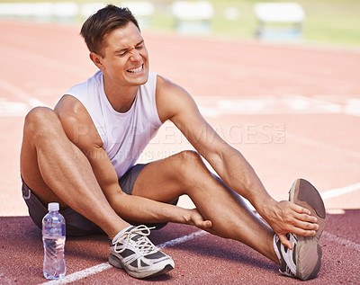 Buy stock photo Athlete, leg pain and man with injury outdoor after exercise, running or workout at a sports stadium. Male person on ground with muscle problem, accident or burnout while training for body fitness