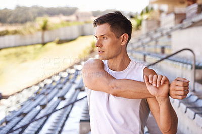 Buy stock photo Shot of an athlete looking into the distance while stretching
