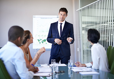 Buy stock photo Shot of a businessman presenting data during a boardroom meeting