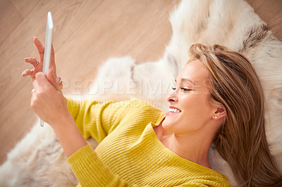 Buy stock photo Tablet, smile and social media with woman on floor of home for browsing, communication or weekend free time. Tech, relax and happy young person in living room of apartment for download from above