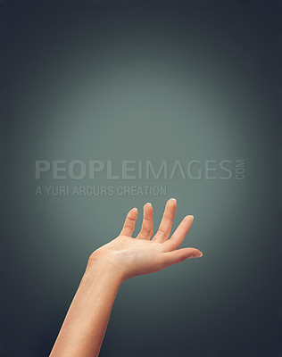 Buy stock photo Hands, help and person reaching in studio for hope, charity or guidance, care or trust on dark background space. Palm, offer and model with mockup for donation, safety or assistance, guide or support