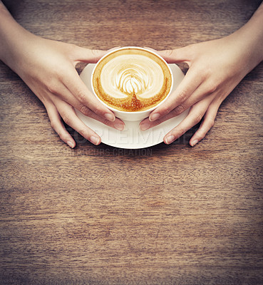 Buy stock photo Hands, coffee and latte art with a customer in a cafe, sitting at a wooden table to relax from above. Wood, mockup and cup with person closeup in a restaurant or bistro to drink a caffeine beverage