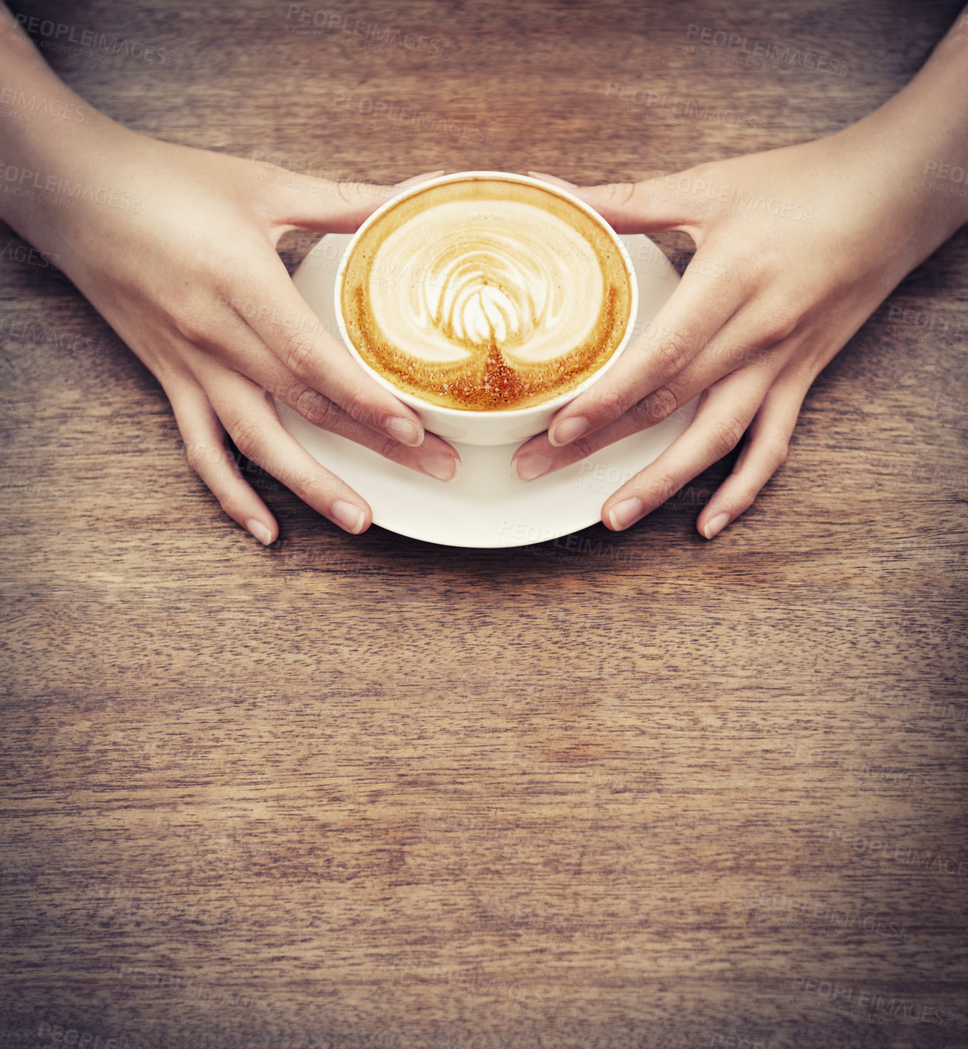 Buy stock photo Hands, coffee and latte art with a customer in a cafe, sitting at a wooden table to relax from above. Wood, mockup and cup with person closeup in a restaurant or bistro to drink a caffeine beverage