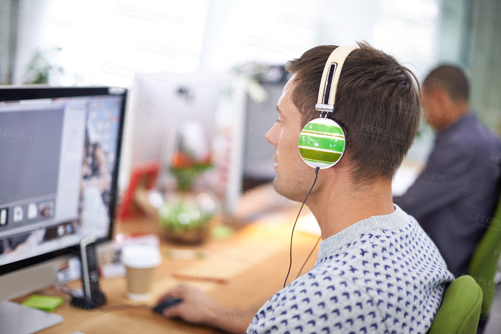 Buy stock photo Business, designer and man with headphones at computer screen in office for creative internship and web design. Employee, rear view and monitor for multimedia production and video animation at desk