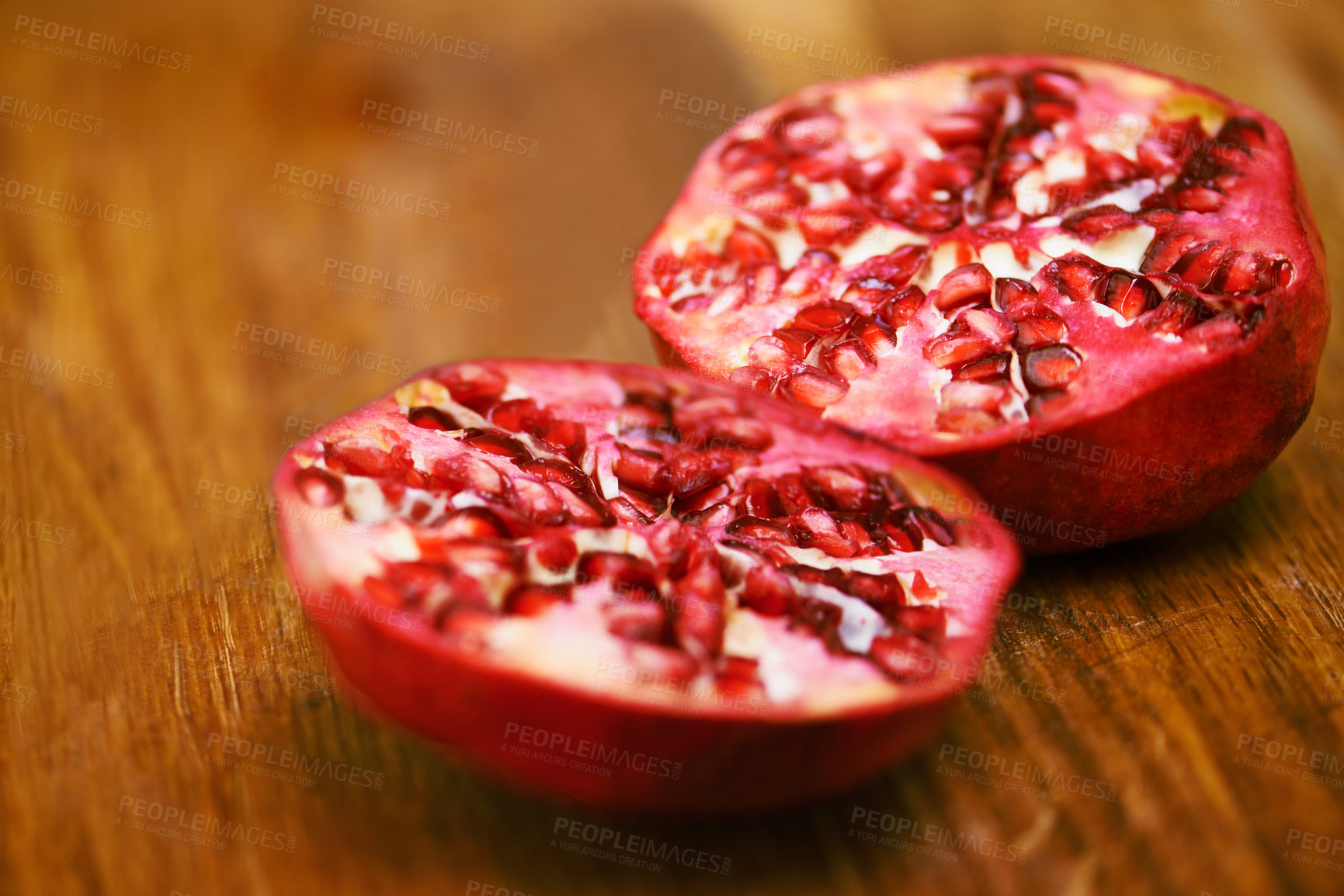 Buy stock photo Food, fruit and pomegranate on wooden table in kitchen for diet, health or nutrition closeup. Wellness, minerals and vitamins with healthy produce on counter or surface in apartment for detox