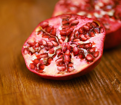 Buy stock photo Wellness, fruit and pomegranate on wooden table in kitchen for diet, health or nutrition closeup. Food, minerals and vitamins with healthy produce on counter or surface in apartment for detox