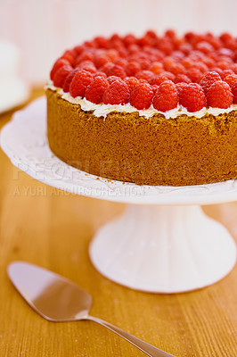 Buy stock photo Plate, spoon and cheesecake with cream and raspberries on table for sweet snack for tea time at home. Bakery, catering and gourmet dessert with crust, frosting and fresh organic fruit in dining room.