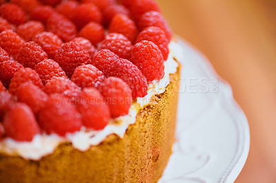 Buy stock photo Plate, frosting and cheesecake with raspberries on table for sweet snack for tea time at home. Bakery, catering and closeup of gourmet dessert with crust, cream and fresh organic fruit in dining room