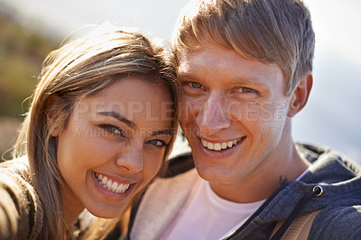 Buy stock photo Portrait of an affectionate young couple standing outside together in the sun