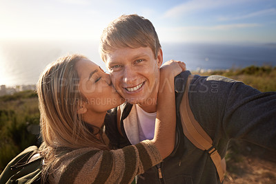Buy stock photo Hiking, kiss and fitness couple with selfie in nature for bonding, fun or romantic memory at sunset. Happy, love and people embrace for profile picture, photography or social media travel blog photo