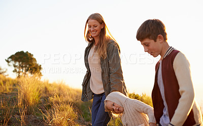 Buy stock photo Happy, mother and children on nature walk, family or fun for health in morning. Exercise and child in countryside with kids holding hands, smile in field on vacation or holiday with people together