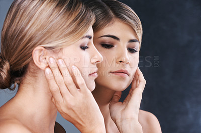 Buy stock photo Face, mirror and skincare with natural woman in studio isolated on blue background for wellness. Aesthetic, beauty and cosmetics with reflection of confident young model at spa for dermatology