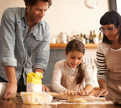 Buy stock photo Mother, father and girl with dough for cooking in kitchen with rolling pin, happy and teaching with support. Family, parents and child with helping, learning and bonding with flour for cake and snack