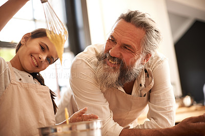 Buy stock photo Girl, child and grandfather with cooking in kitchen for mixing, baking and teaching with support and whisk. Family, senior man and grandchild with dough preparation in home for bonding and learning