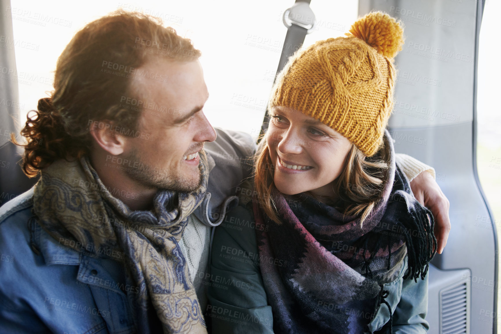 Buy stock photo Couple, hug and smile together in car, travel and bonding with road trip for date or anniversary. Love, trust and commitment with partner, loyalty and cuddle for warmth in winter, vacation and happy