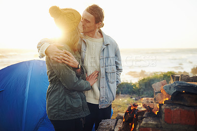 Buy stock photo Happy couple, love and bonding together by campfire, blanket and romantic getaway with camping in forest. Man, woman and relax on vacation on weekend break, countryside and travel in woods for sunset