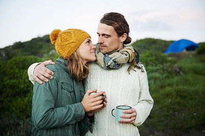 Buy stock photo Hiking, couple and drinking coffee in nature on vacation, holiday or travel together in winter on adventure. Camping, man and woman with tea cup outdoor in the countryside, embrace and love on date