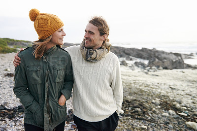 Buy stock photo Walking, love and couple by ocean in winter for bonding, romantic relationship and relax outdoors. Marriage, travel and happy man and woman by sea for holiday, vacation and weekend together in nature