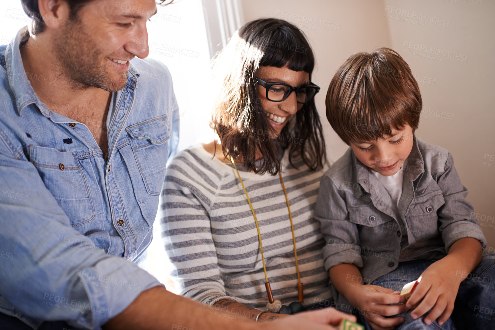 Buy stock photo Parents, boy and together in family home, smile and happy laughing while playing with toy. Kid, development for growth or learning and love on vacation, holiday or bond and caring mother or father