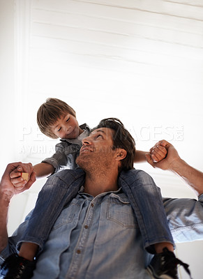 Buy stock photo Family, carry and son on shoulders of father in home from below for bonding, fun or relationship. Love, smile or happy with man parent and boy child in apartment together for development or growth