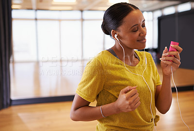 Buy stock photo Music, girl and dancer listening with earphones connect on digital device in studio or gym in weekend. Audio, female person and woman streaming songs on app to relax with technology and sound