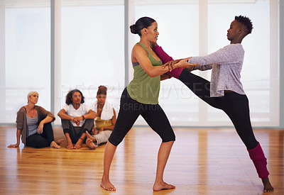 Buy stock photo Stretching, women and dance in gym with partner, personal trainer and African friends together at fitness class. Rhythm, moving and people in studio for practice, performance and flexibility of legs
