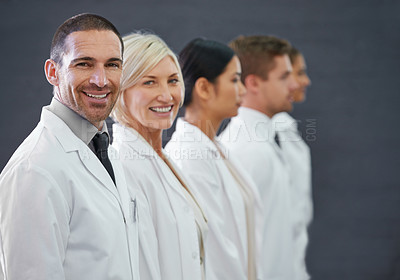Buy stock photo Cropped shot of a group of doctors standing in a row