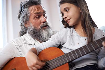 Buy stock photo Grandfather teaching girl to play guitar, learning and development in music with help in creativity. Musician, art and senior man helping female kid learn focus and skill on musical instrument