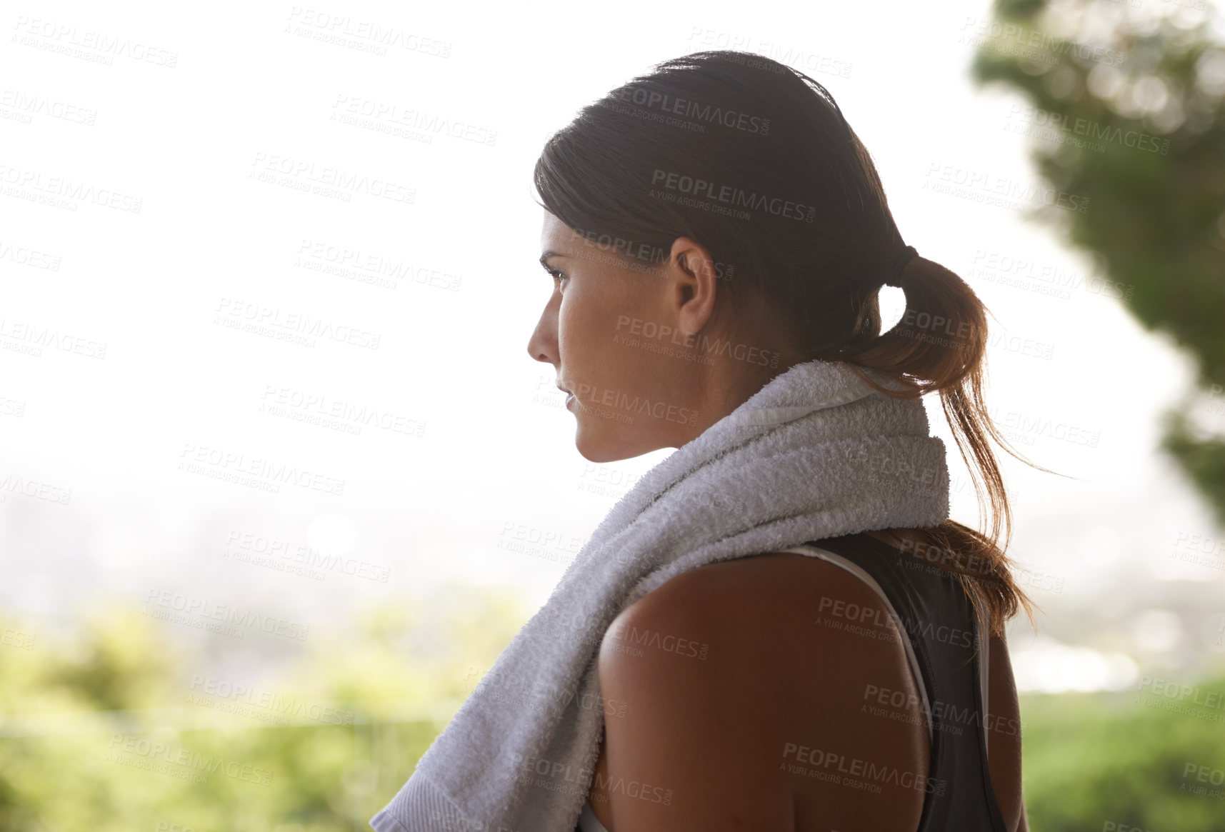 Buy stock photo Shot of an attractive young woman working out in a studio with a view