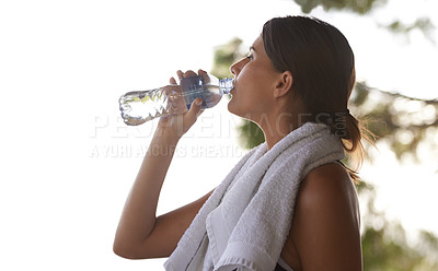Buy stock photo Fitness, break and woman with towel drinking water for break, hydration and commitment to yoga workout. Gym, bottle and serious girl with exercise, training and pilates for health, wellness and trees